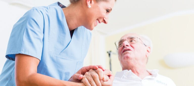 Caregiver interacting with a resident in a bright room