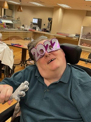 Resident celebrating New Year's with fun props