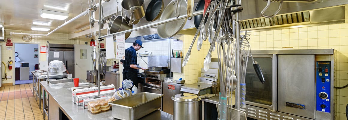 Staff member preparing food in a commercial kitchen