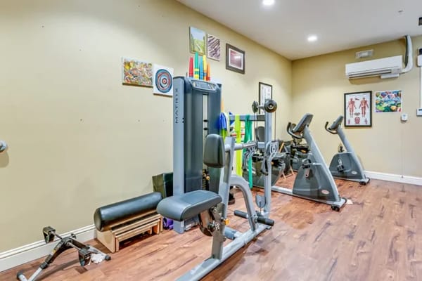 Fitness equipment in a well-lit exercise room