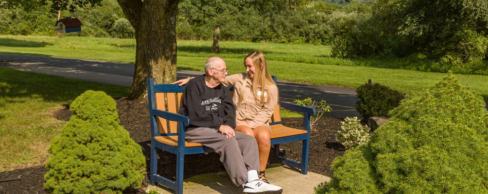 Senior resident and staff member enjoying time outdoors