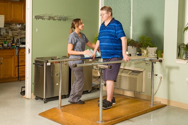 Patient receiving assistance with walking therapy