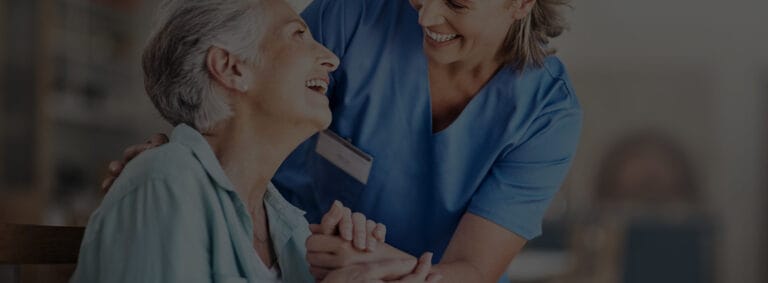 Caregiver interacting joyfully with a resident