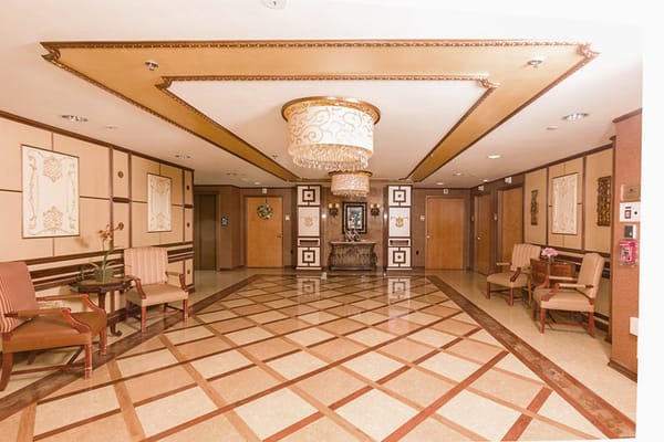 Elegant lobby with chandelier and seating area