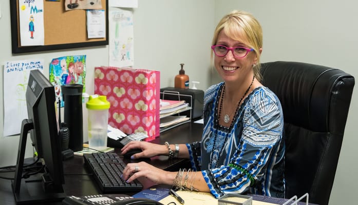 Staff member working at a desk with a computer
