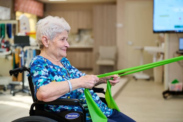 Senior resident participating in a therapy exercise class
