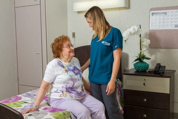 Staff member interacting with a resident in a cozy room