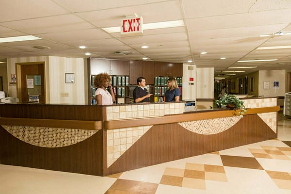 Staff members interacting at the facility reception area