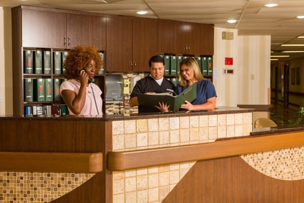 Staff members interacting at the reception desk