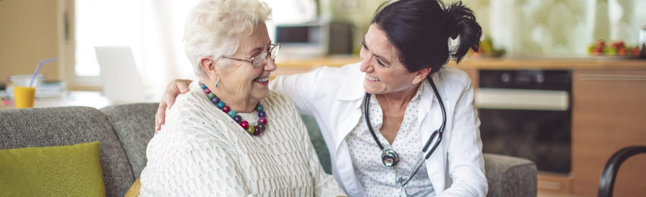 Staff member engaging with a smiling resident
