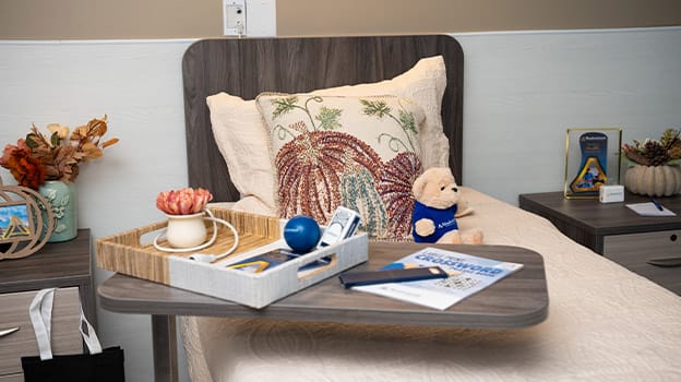 Cozy resident room with a decorative pillow and personal items