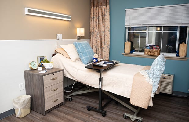 Private resident room with a bed and personal items