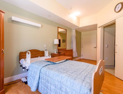 Comfortable private resident room with a bed and furniture