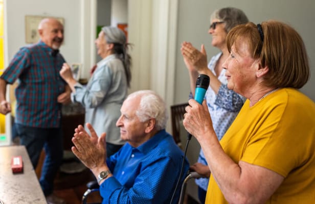 Residents engaged in a joyful karaoke activity