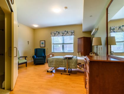 Private resident room with bed and seating area