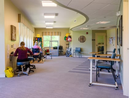 Activity room with residents engaged in therapy sessions