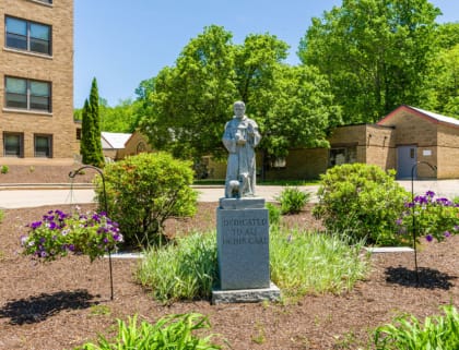 Statue in a landscaped garden area outside the facility
