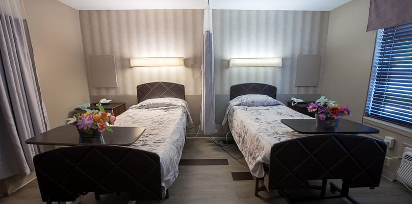 Cozy private resident room with two beds and floral decor