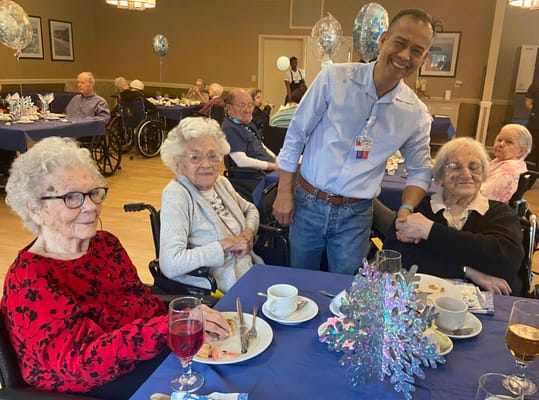 Residents enjoying a celebration with staff member