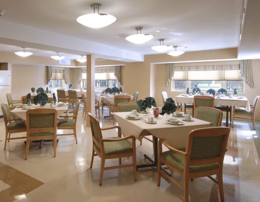 Dining area with tables and chairs set for meals