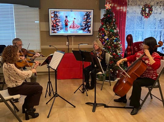 Musicians performing during a holiday celebration inside