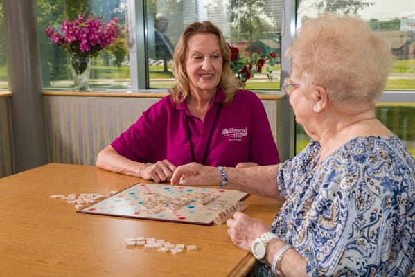 Caregiver playing a game with a resident