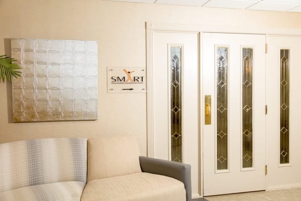 A cozy interior lounge area with seating and signage