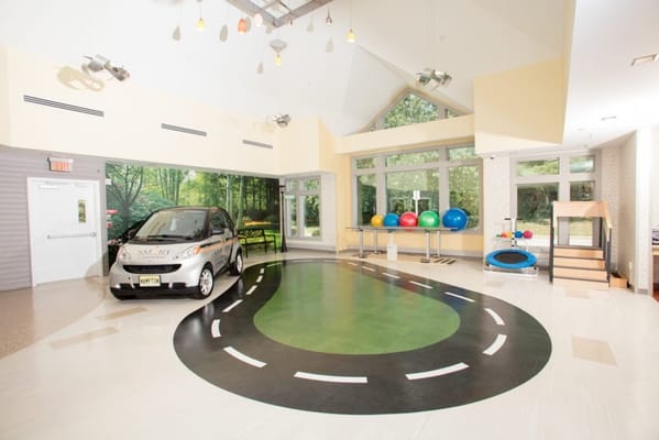 Interior view of a common area with toy car and exercise balls