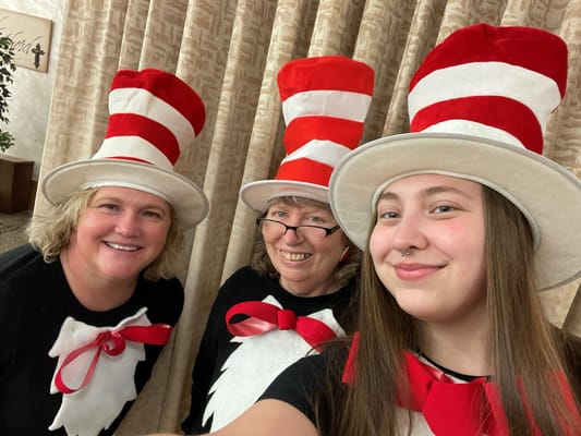 Staff and residents celebrating with Cat in the Hat hats
