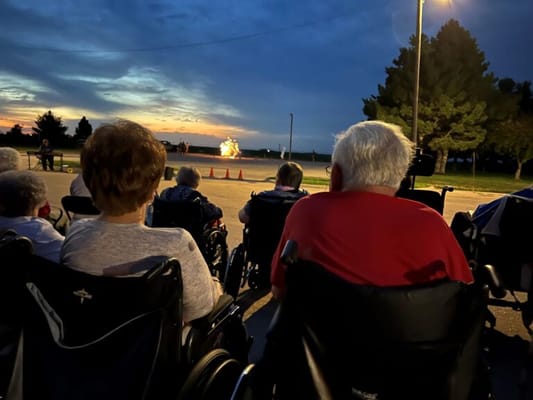 Residents enjoying an outdoor evening event with fireworks