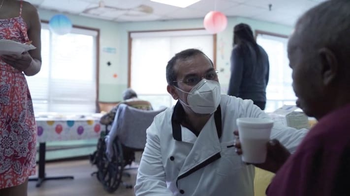 Staff attending to a resident in a communal area
