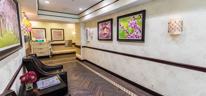 Well-decorated hallway with floral paintings and seating