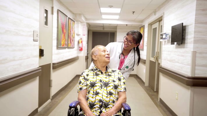 Staff member assisting a resident in a hallway
