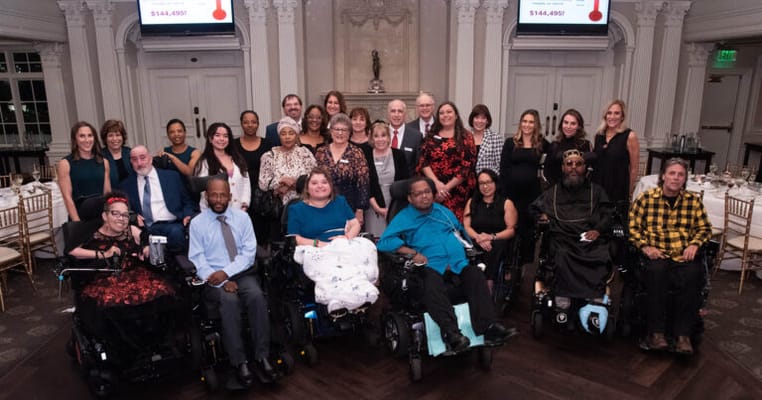 Group photo of residents and staff at a celebration event