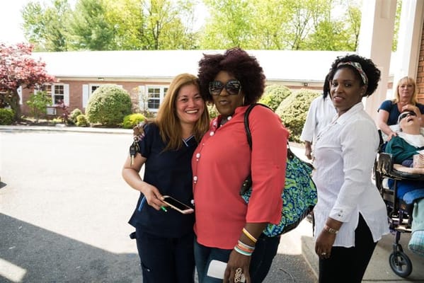 Two smiling women pose for a photo outdoors