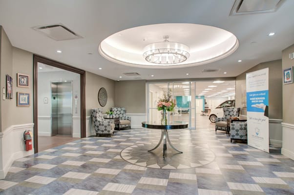 Bright lobby area with seating and floral arrangement