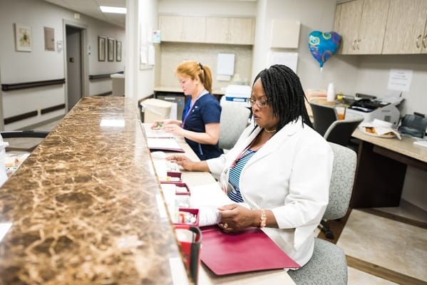 Staff members working at the reception desk