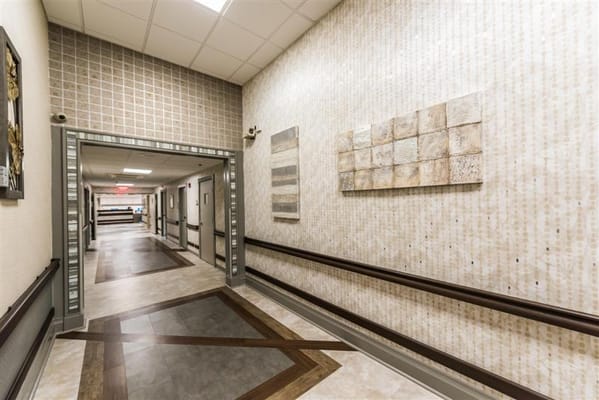 Brightly lit hallway with textured walls and artwork