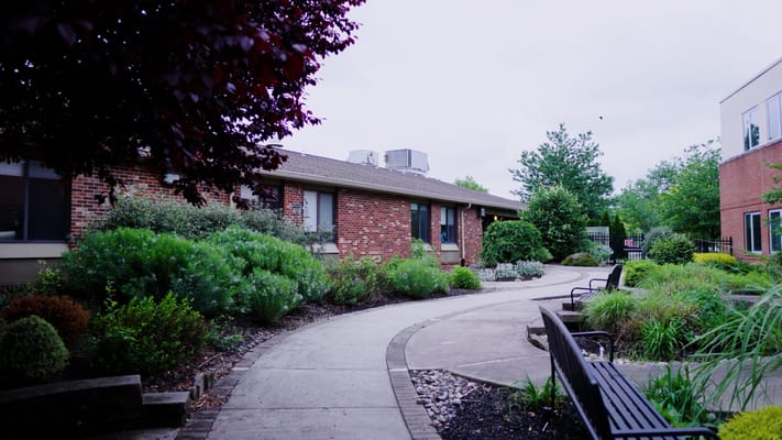 Pathway through a landscaped outdoor area of a senior facility