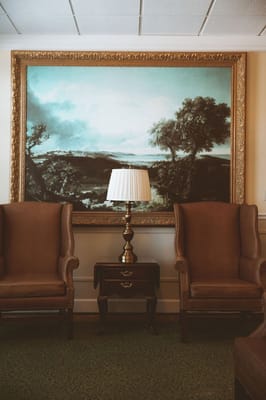 Cozy seating area with artwork and lamp