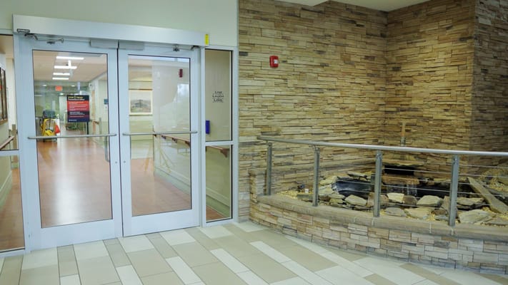Interior view of a nursing home entrance with stone decor