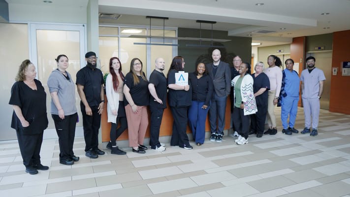 Staff posing together in a common area