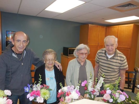 Residents participating in a flower arrangement activity