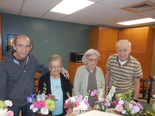 Residents participating in a flower arrangement activity