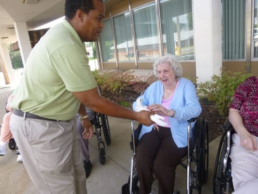 Staff member interacting with a resident outdoors