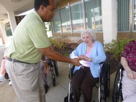 Staff member interacting with a resident outdoors