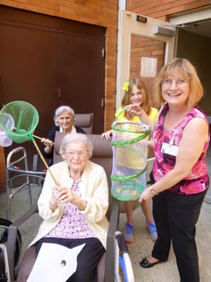 Residents and staff engaging in an outdoor activity with butterflies