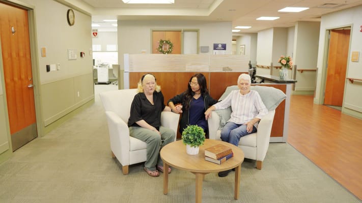 Three residents enjoying conversation in a common area