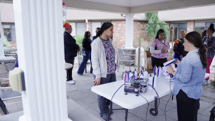 Residents and staff celebrating an event outdoors