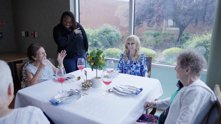 Residents enjoying a meal together with staff